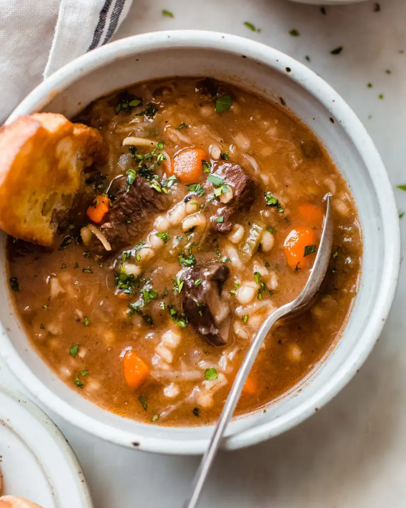 Slow Cooker Beef Barley Soup served in a white bowl