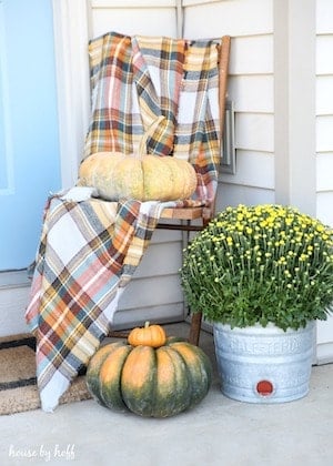 fall front stoop with plaid blanket mums and pumpkins