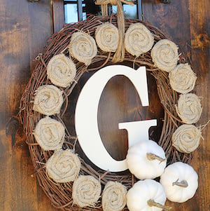 fall wreath with burlap roses and white pumpkins