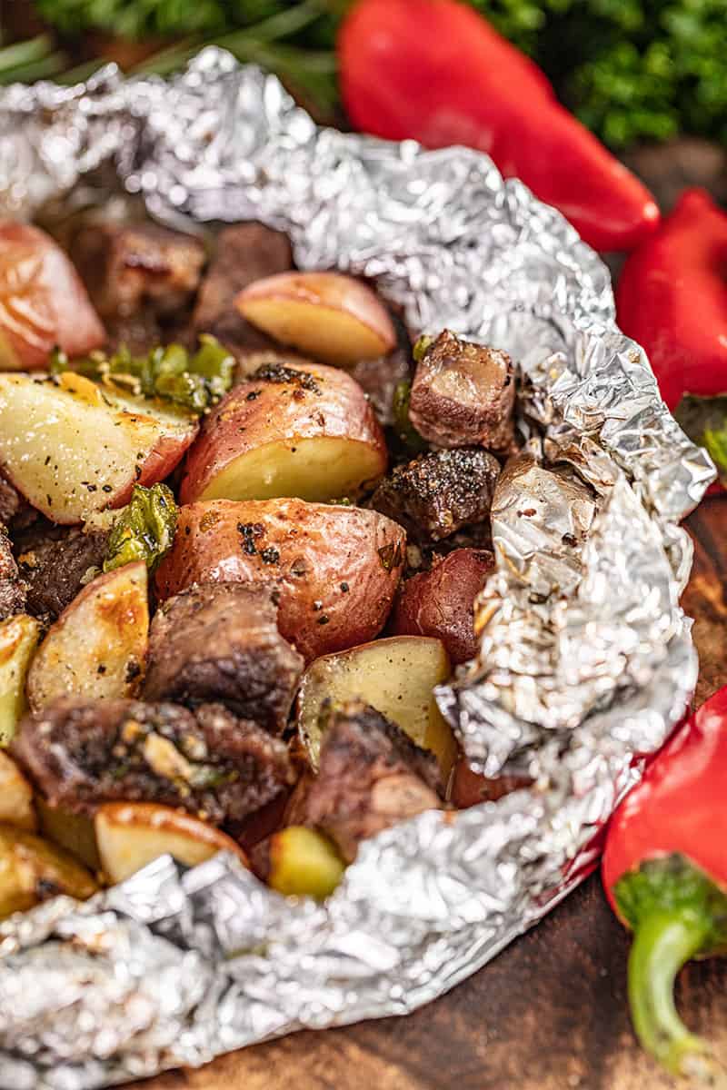 A variety of colorful and delicious foil packets for the oven featuring chicken foil packets, vegetable foil packets, and seafood foil packets in aluminum foil.