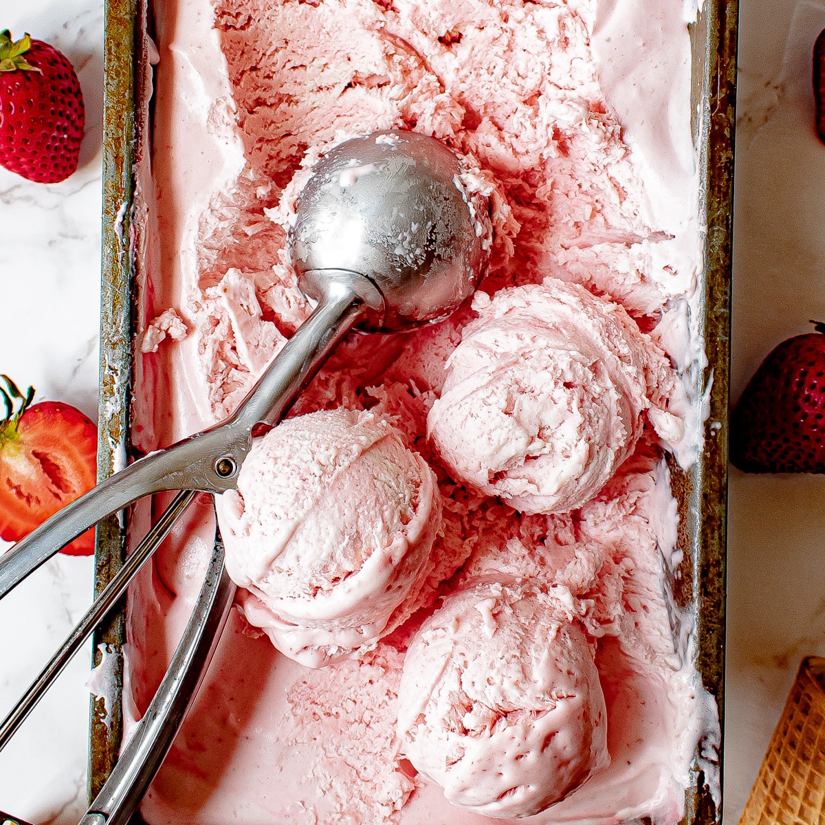 A variety of homemade ice cream flavors including strawberry, vanilla, and mint chocolate chip in colorful bowls.