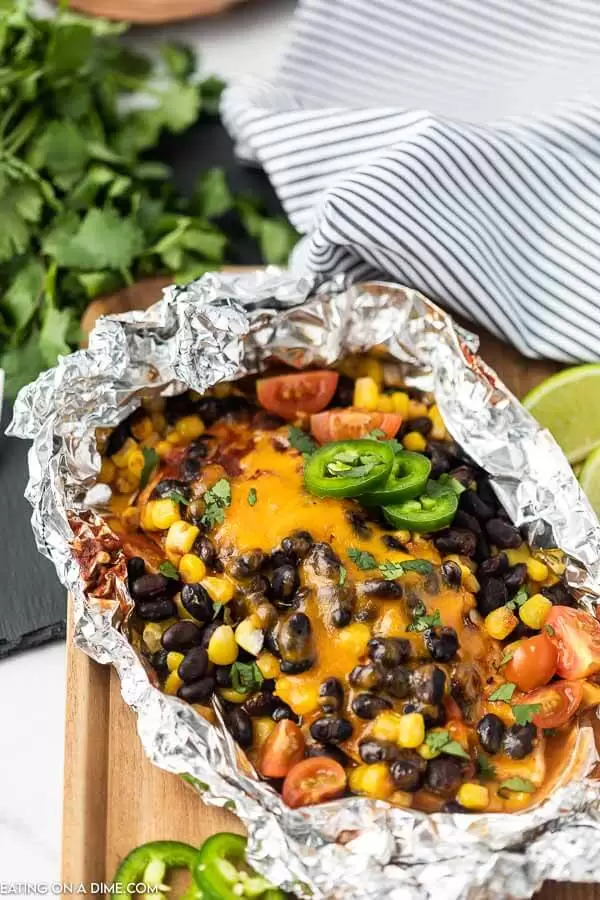 A variety of colorful and delicious foil packets for the oven featuring chicken foil packets, vegetable foil packets, and seafood foil packets in aluminum foil.