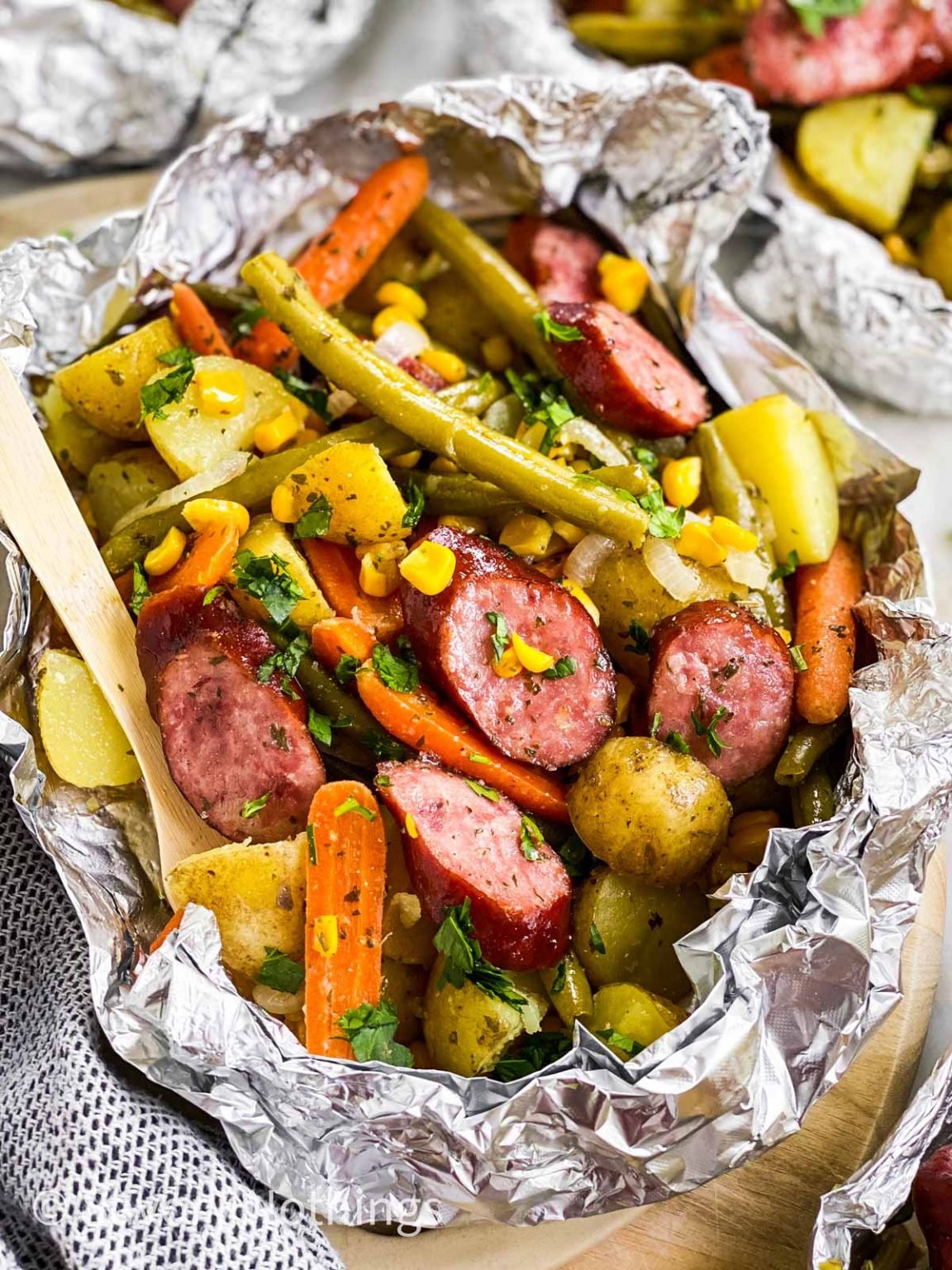 A variety of colorful and delicious foil packets for the oven featuring chicken foil packets, vegetable foil packets, and seafood foil packets in aluminum foil.