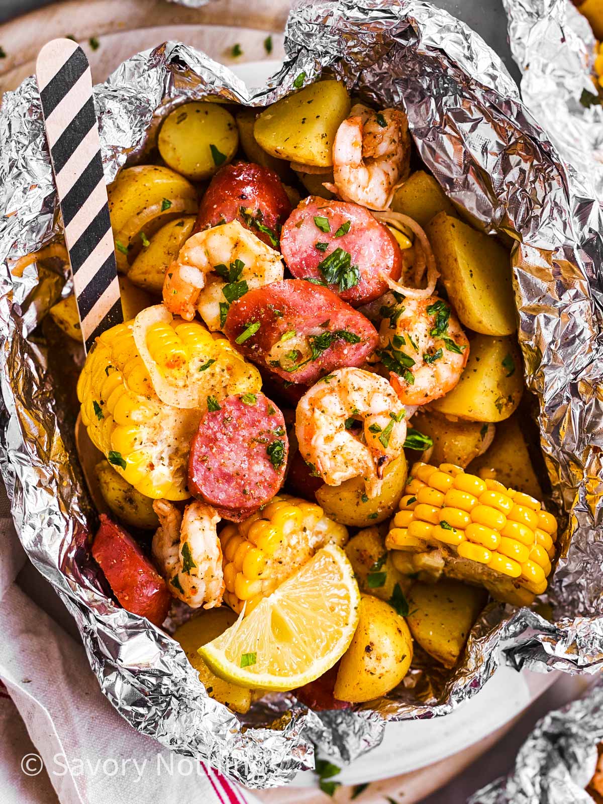 A variety of colorful and delicious foil packets for the oven featuring chicken foil packets, vegetable foil packets, and seafood foil packets in aluminum foil.