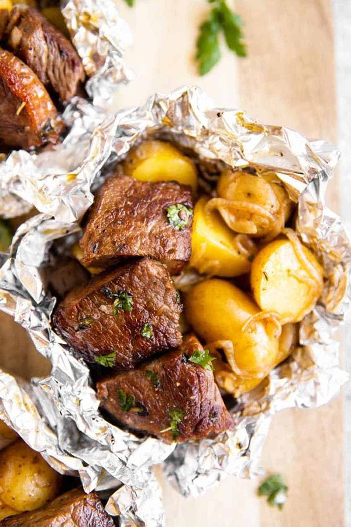 A variety of colorful and delicious foil packets for the oven featuring chicken foil packets, vegetable foil packets, and seafood foil packets in aluminum foil.